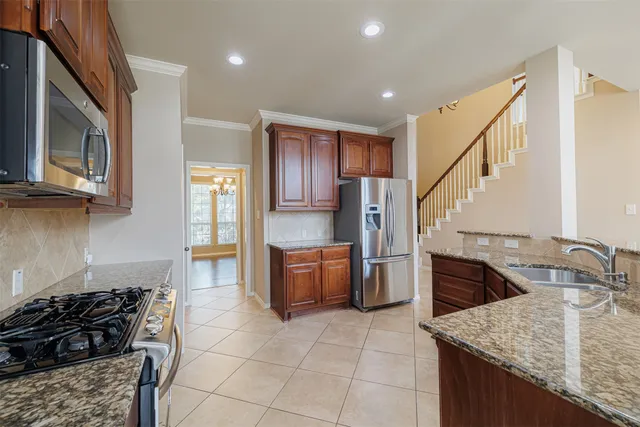 a kitchen with a stove a sink and a refrigerator