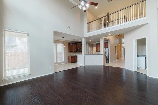 a view of an entryway with wooden floor and a kitchen