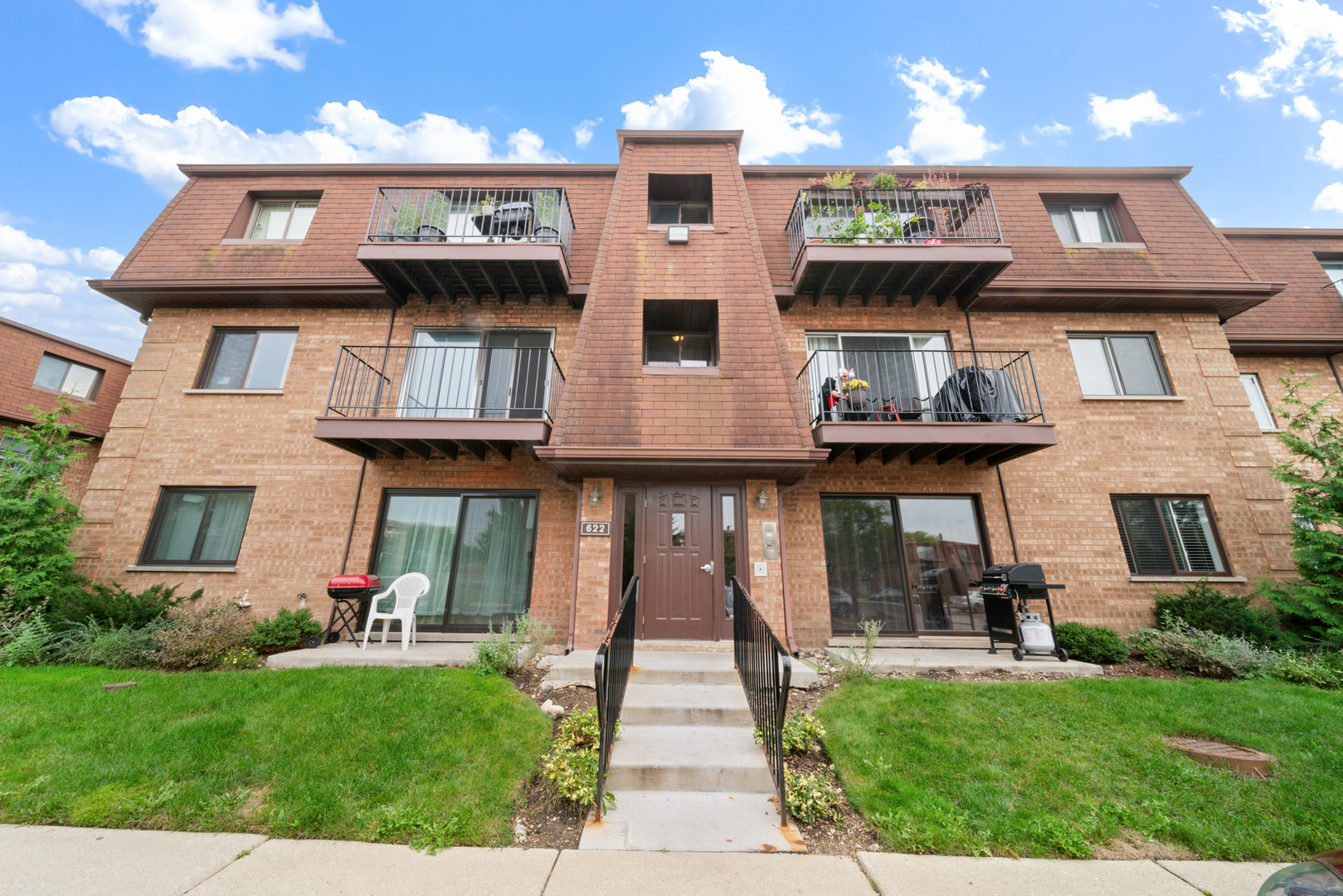 a front view of a house with garden