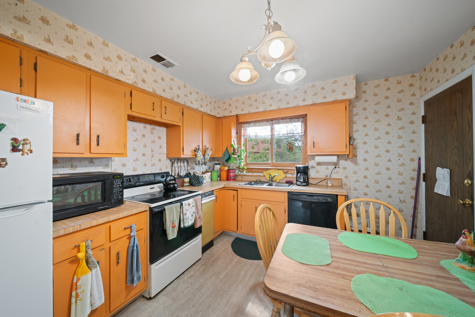 622 Cobblestone Circle, Unit C Glenview, IL 60025 - Photo 11 of 20 a kitchen with stainless steel appliances granite countertop a stove top oven a sink dishwasher a dining table and chairs with wooden floor