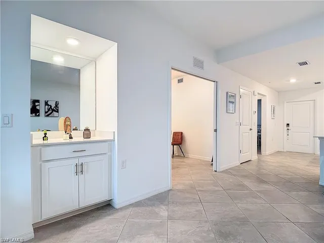 a view of a hallway to closet and utility room