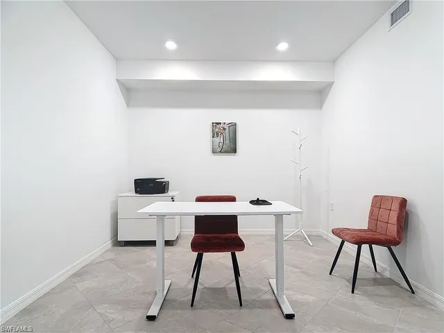 a view of a workspace with furniture