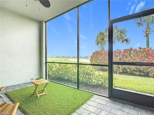a view of a porch with furniture and a gate