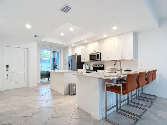 a kitchen with counter top space cabinets and stainless steel appliances