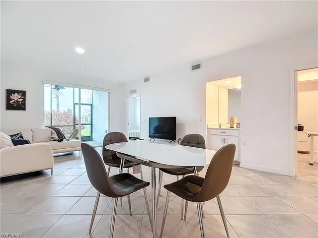a view of a dining room with furniture and a window