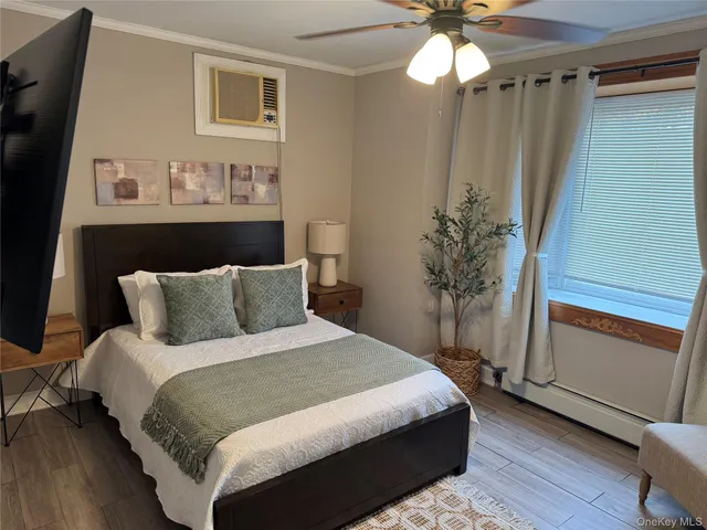 a bedroom with a bed and a potted plant