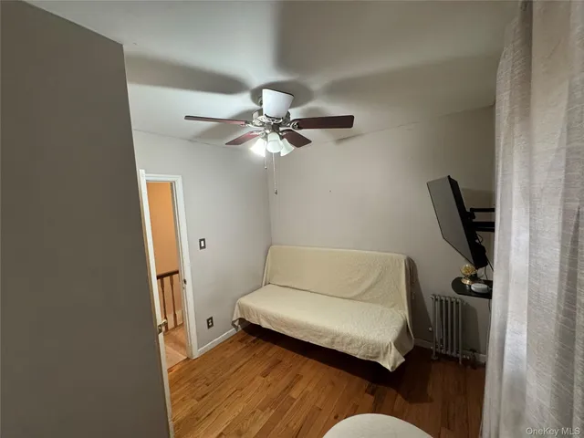 a living room with furniture and a ceiling fan