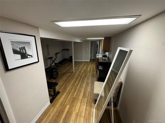 a view of a livingroom with wooden floor and stairs