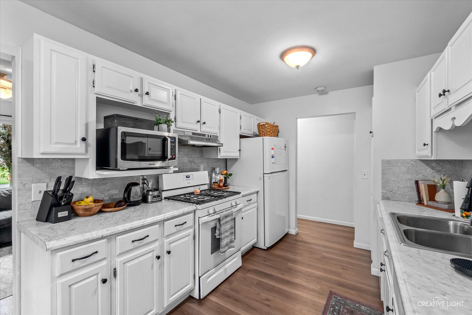 8 Shermead Road Montgomery, IL 60538 - Photo 7 of 17 a kitchen with stainless steel appliances white cabinets and a refrigerator