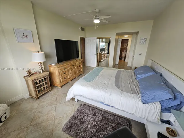 a bedroom with a bed and a television