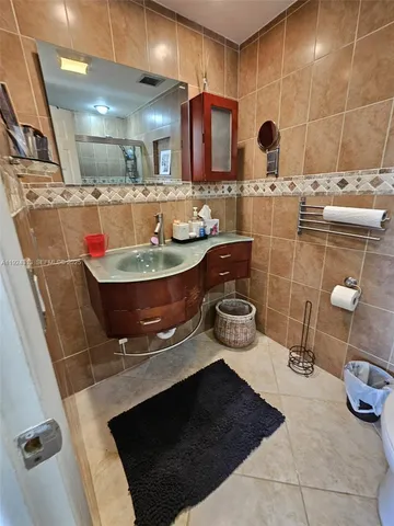 a bathroom with a sink mirror and toilet