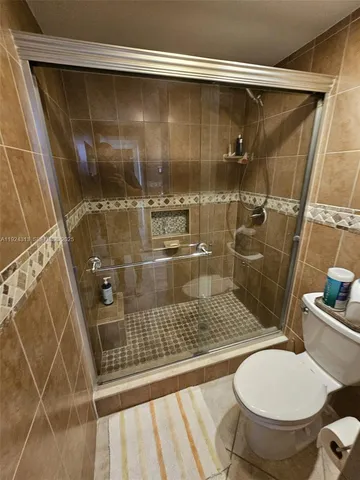 a bathroom with a shower and toilet