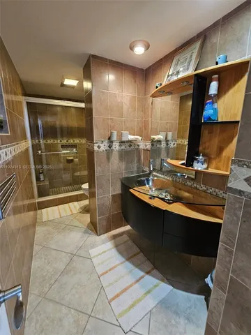 a kitchen with stainless steel appliances a sink stove and refrigerator