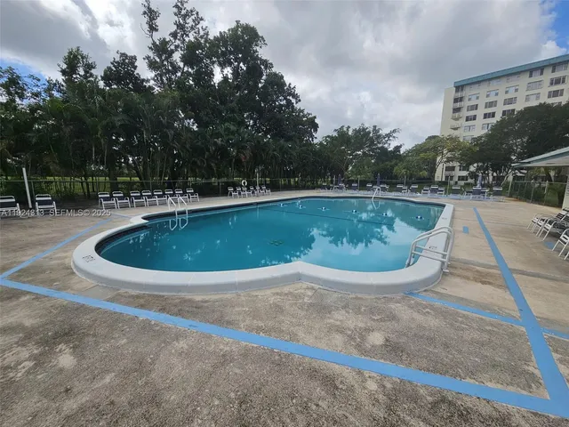 a view of a swimming pool in back of a house