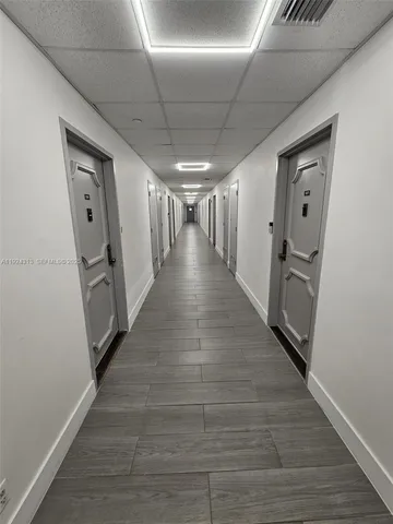 a view of hallway with wooden floor