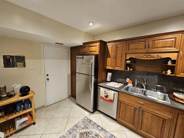 a kitchen with stainless steel appliances granite countertop a refrigerator and a sink