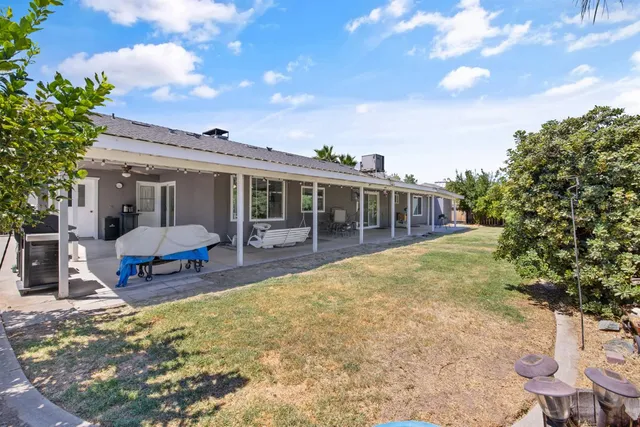 a view of a house with swimming pool and sitting area