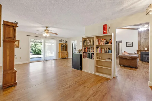 a view of a kitchen with furniture and wooden floor