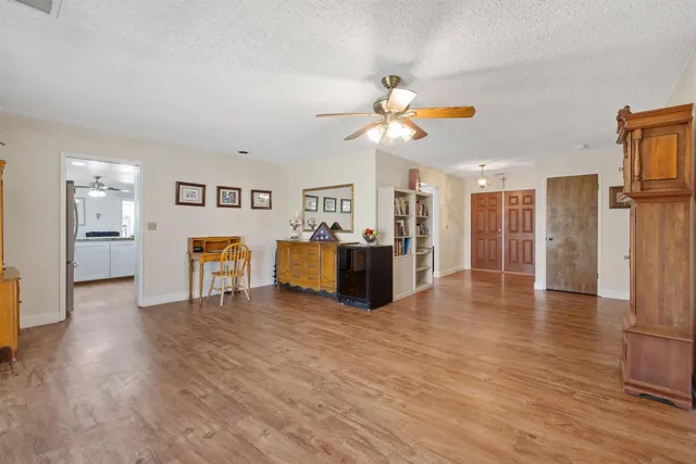 a view of a kitchen with furniture and wooden floor