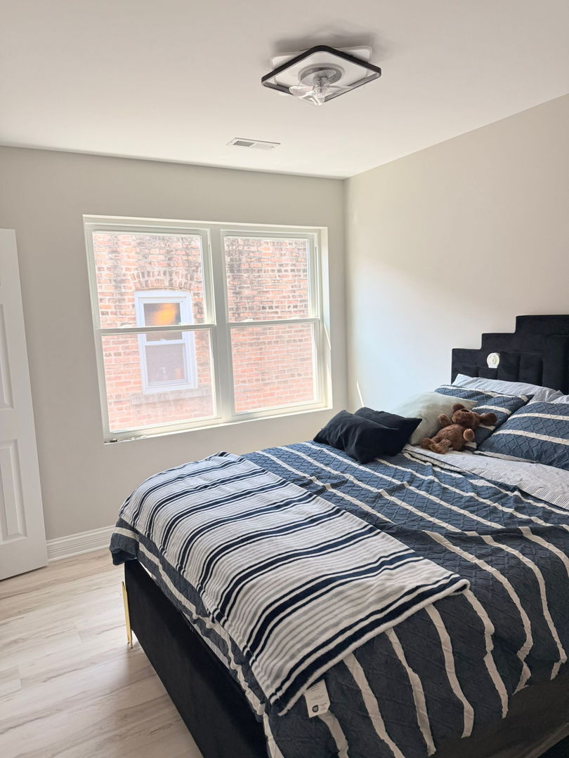 1051 North Springfield Avenue Chicago, IL 60651 - Photo 10 of 50 a bedroom with a bed and a window