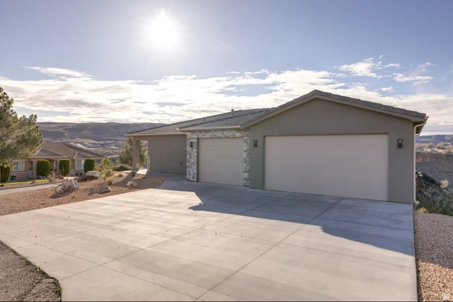 217 West Terrace Circle Toquerville, UT 84774 - Photo 1 of 25 Ranch-style home with stucco siding, driveway, a garage, and stone siding