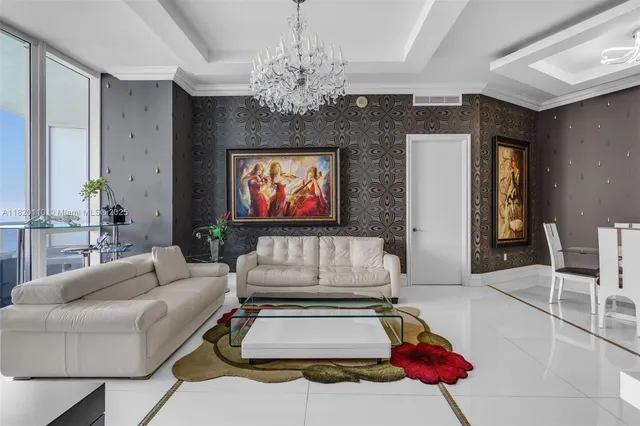 a living room with furniture and a chandelier