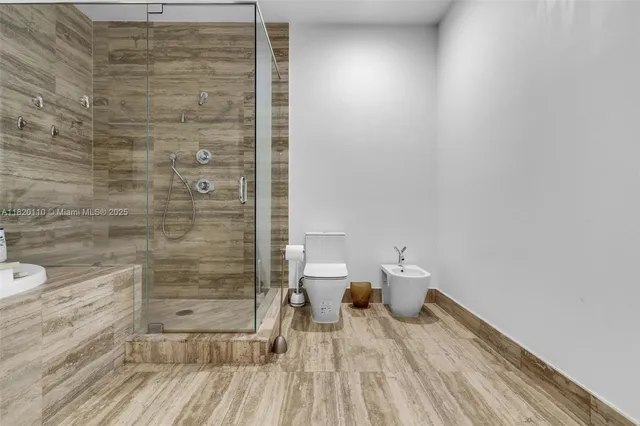 a bathroom with a toilet and a shower