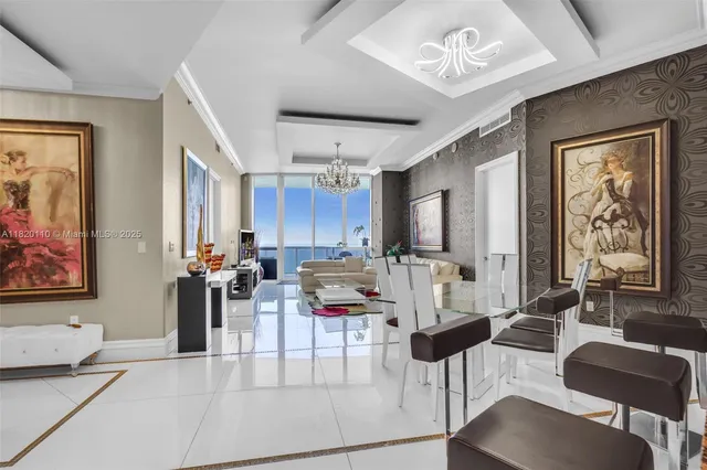 a living room with furniture and large windows