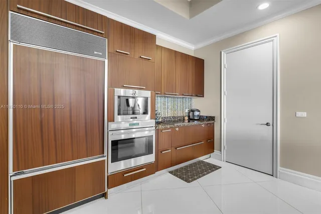 a kitchen with a refrigerator and cabinets