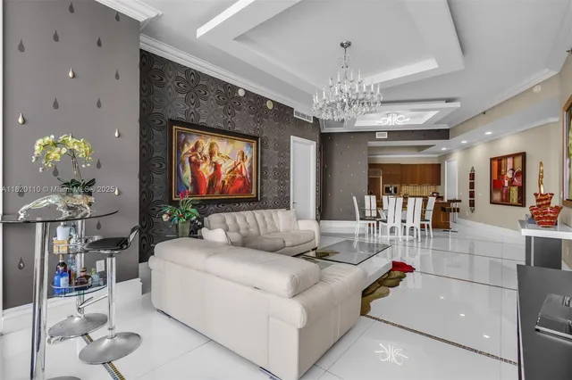 a living room with furniture and a chandelier