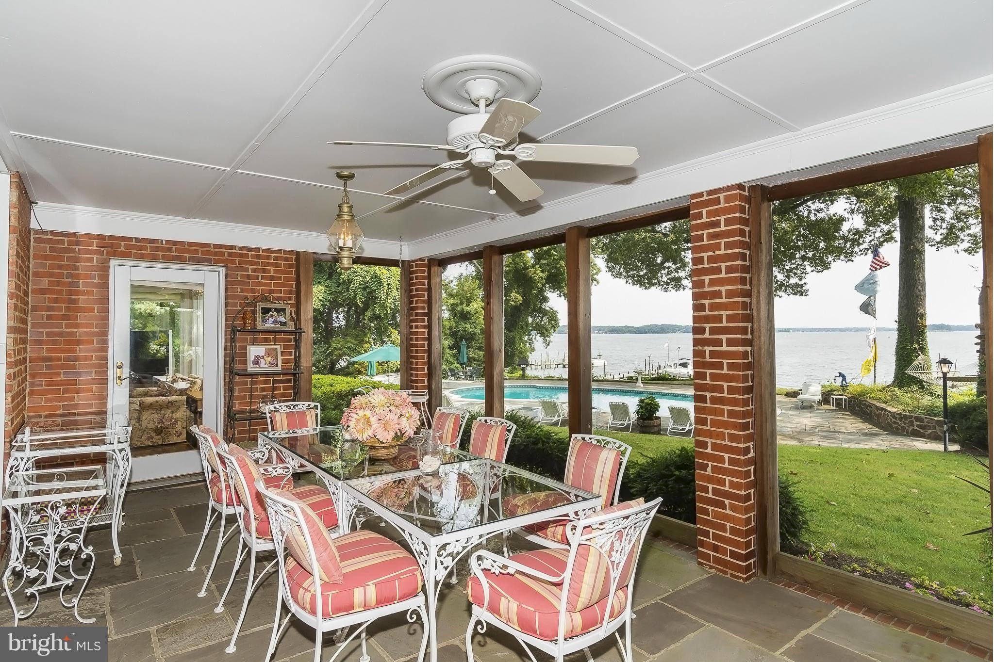 525 Broadwater Road Arnold, MD 21012 - Photo 22 of 30 Sunny screened porch overlooks waterside pool.