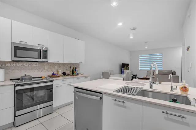 a kitchen with a sink stove and microwave