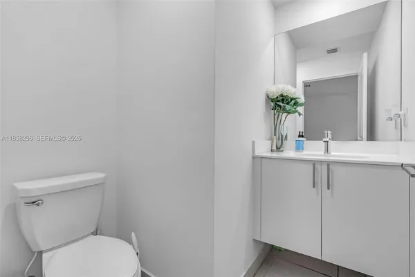 a bathroom with a toilet a sink and mirror