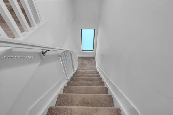 a view of staircase with white walls