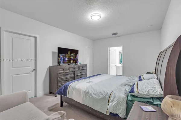 a bedroom with a bed and a television