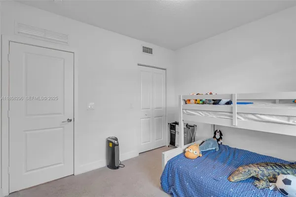 a bedroom with furniture and a wooden floor