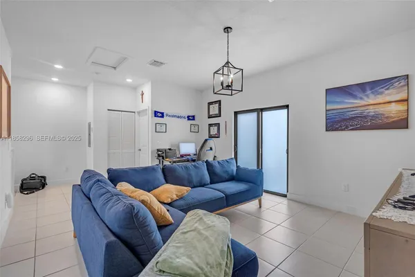 a living room with furniture a couch and a chandelier