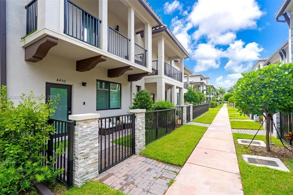 a view of a brick house with a yard
