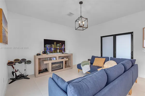 a living room with furniture a couch and a chandelier