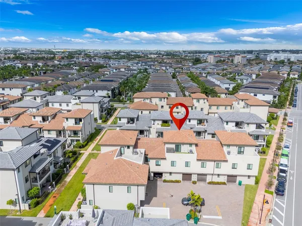 an aerial view of residential houses with outdoor space