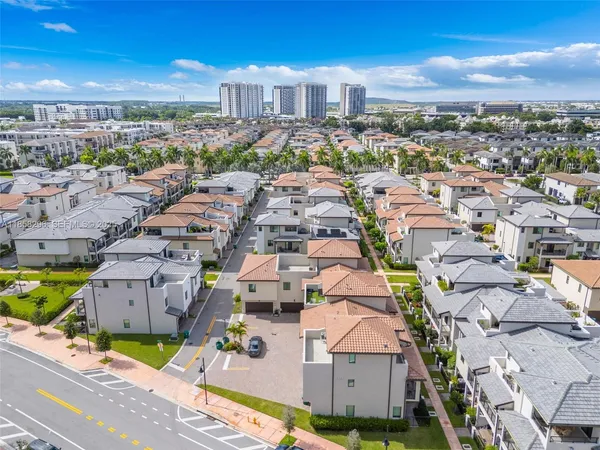 an aerial view of residential houses with city view