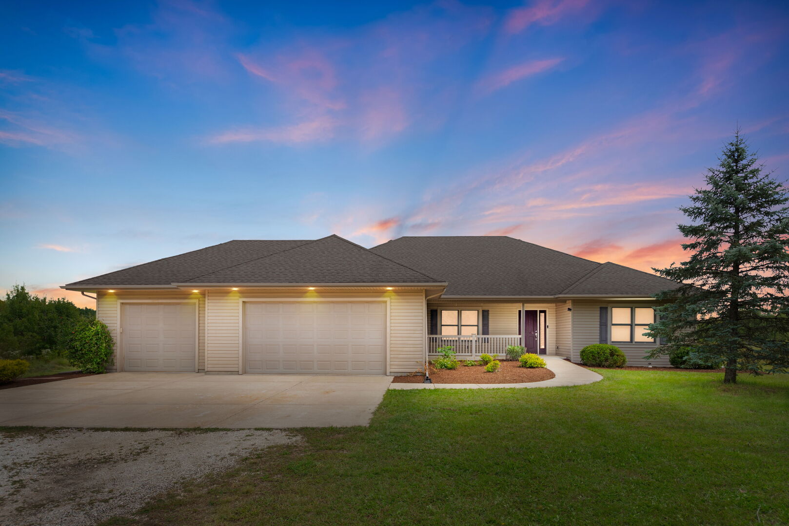 a front view of a house with a garden