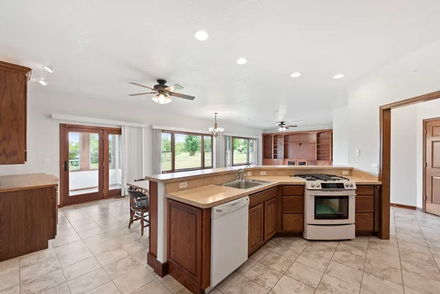 a kitchen with a stove sink and cabinets