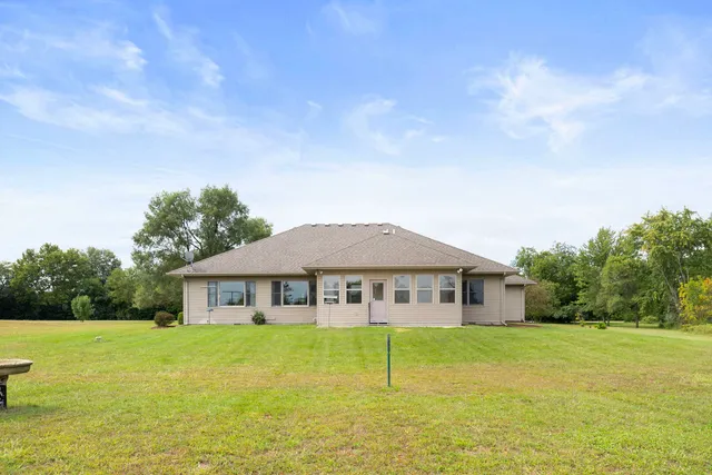 a yellow house with swimming pool in front of it