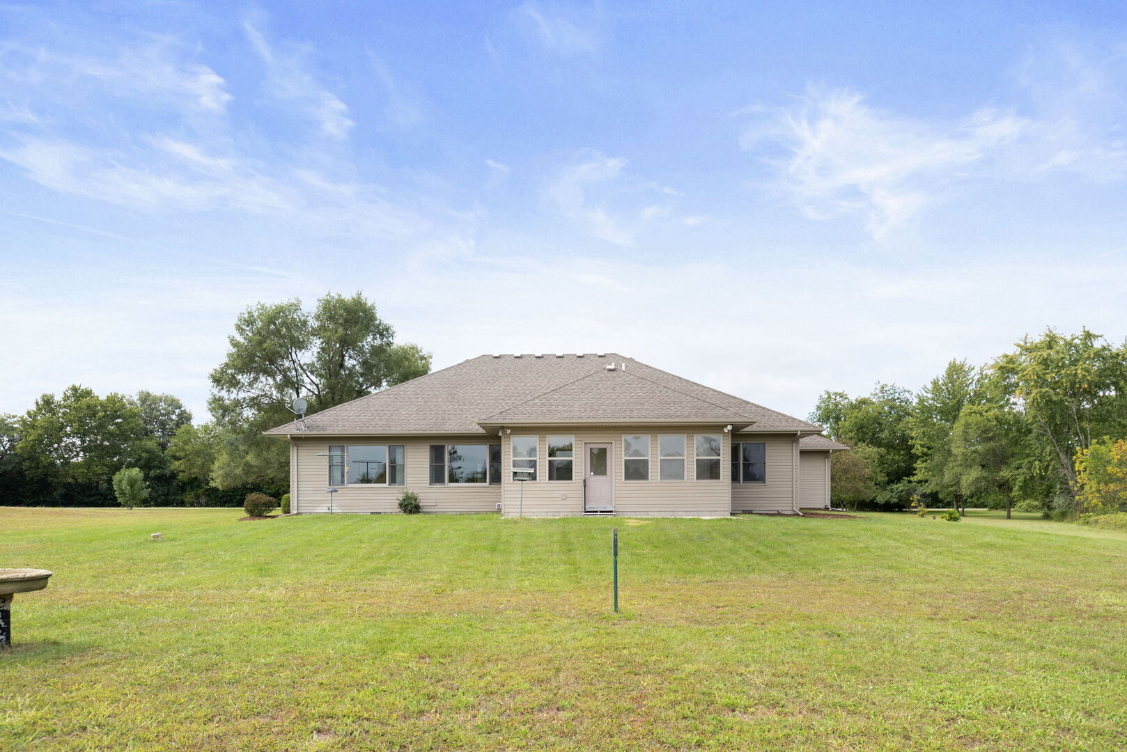 2745 South Hieland Road St. Anne, IL 60964 - Photo 25 of 31 a yellow house with swimming pool in front of it