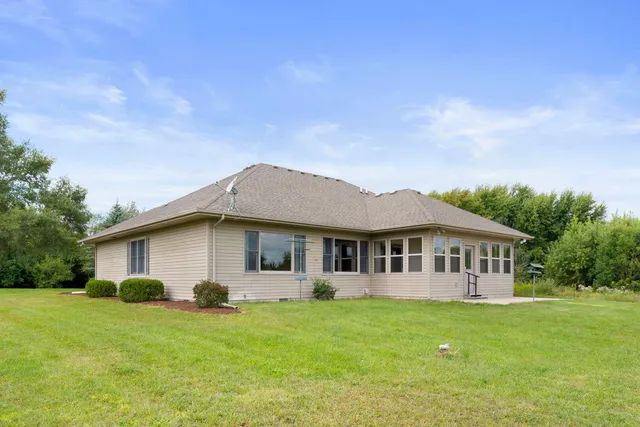 a view of a house with a backyard