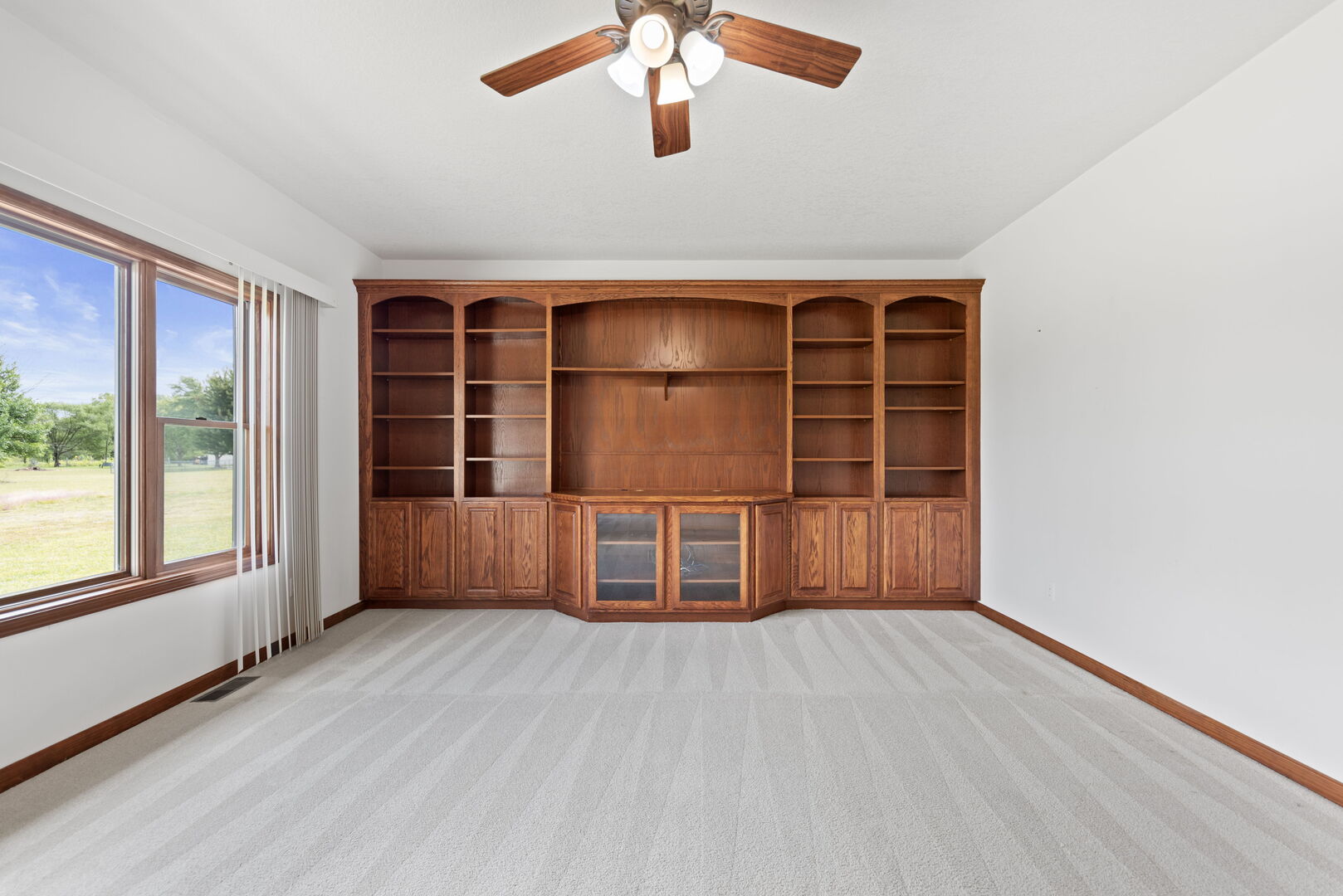 2745 South Hieland Road St. Anne, IL 60964 - Photo 4 of 31 an empty room with wooden floor and windows