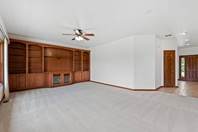 a view of an empty room with a ceiling fan
