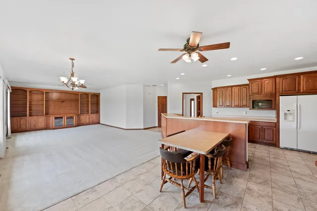 a view of a dining room with furniture and a chandelier