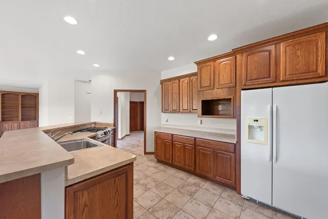 a kitchen that has a sink a stove and chairs
